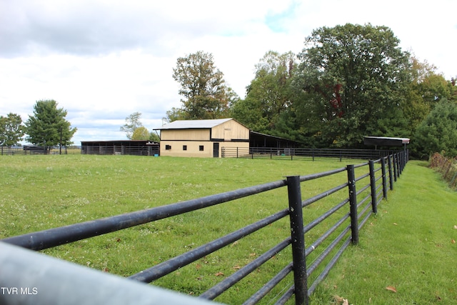 view of yard featuring an outdoor structure and a rural view