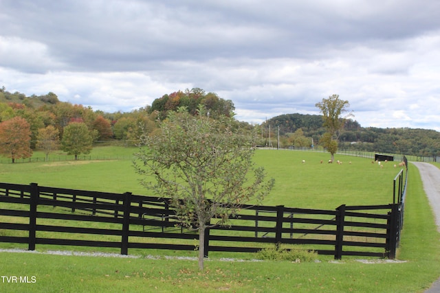 view of gate featuring a rural view and a yard