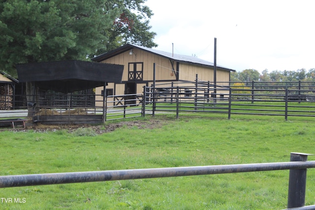 view of yard with a rural view and an outbuilding