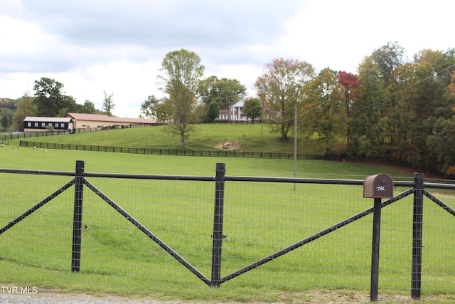 exterior space featuring a rural view and a lawn