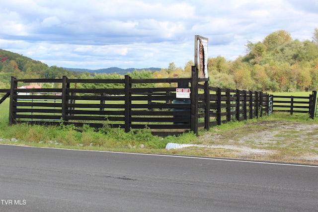 view of gate with a mountain view and a rural view