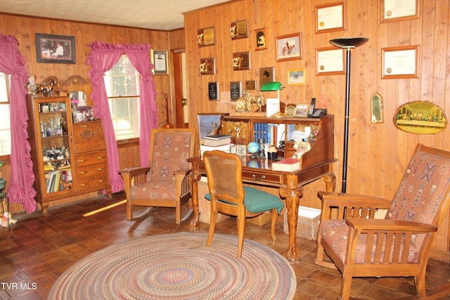 sitting room featuring wooden walls