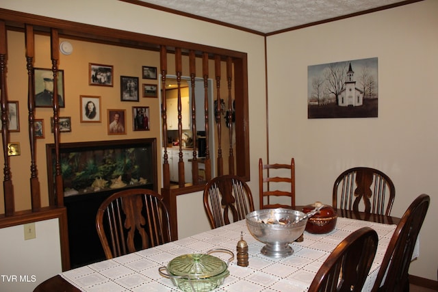 dining room featuring ornamental molding and a textured ceiling