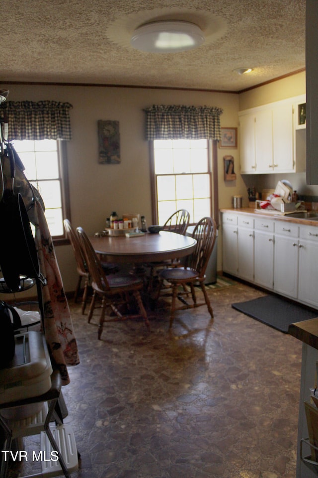 dining area with a textured ceiling and sink