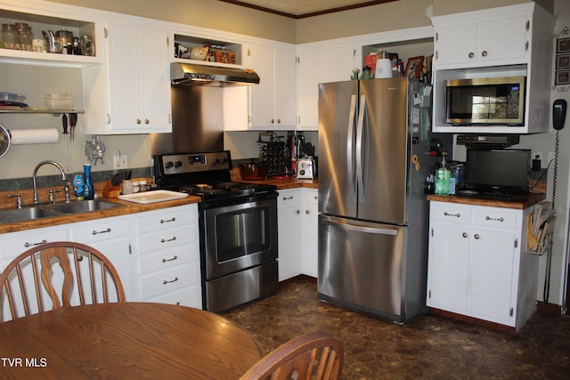 kitchen with stainless steel appliances, white cabinetry, and sink