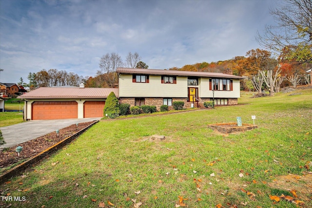 bi-level home featuring a garage and a front yard