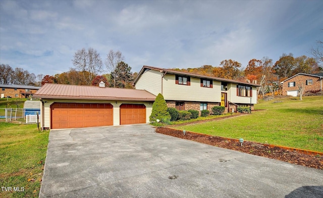 view of front of property with a garage and a front lawn