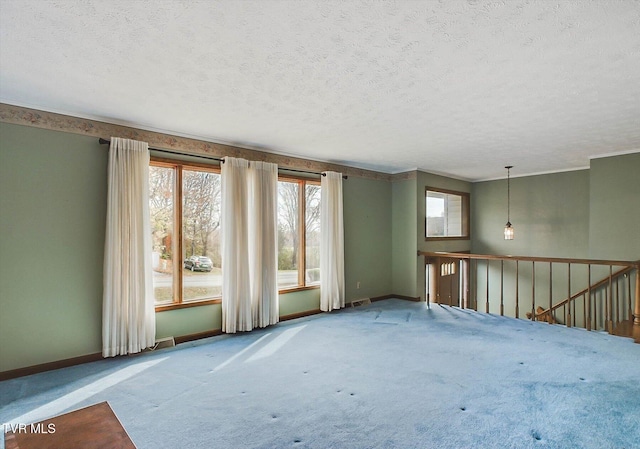 empty room featuring carpet flooring and a textured ceiling