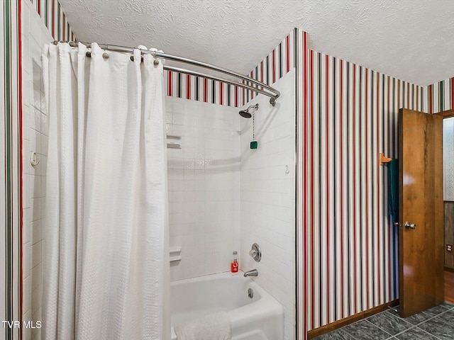 bathroom with tile patterned flooring, shower / tub combo, and a textured ceiling