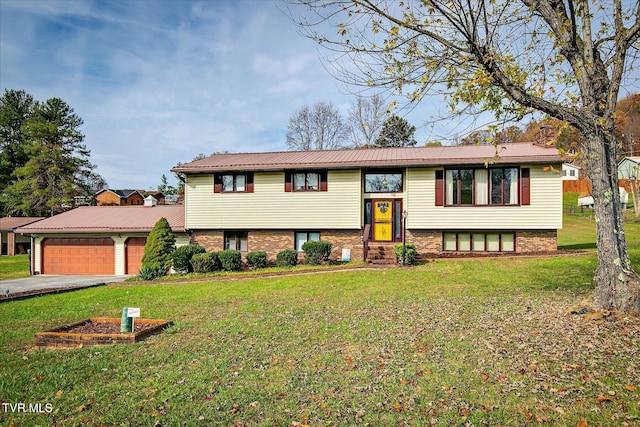 raised ranch with a front yard and a garage