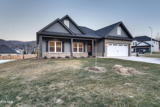 craftsman inspired home featuring a front yard and a garage