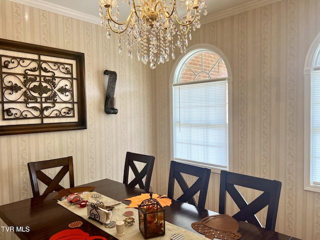 dining area with plenty of natural light, crown molding, and an inviting chandelier