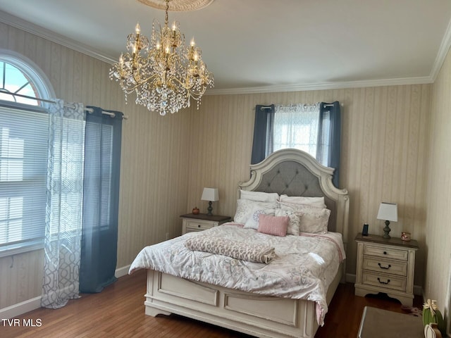 bedroom featuring dark hardwood / wood-style floors, an inviting chandelier, and ornamental molding