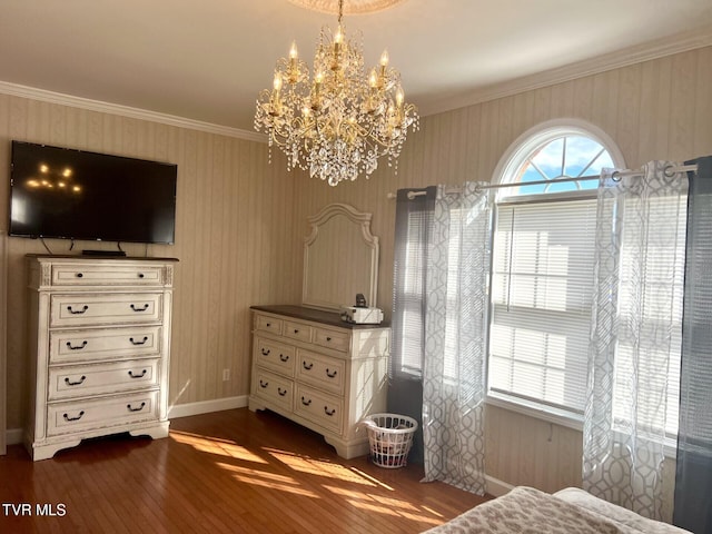 bedroom with dark hardwood / wood-style floors, a notable chandelier, and ornamental molding