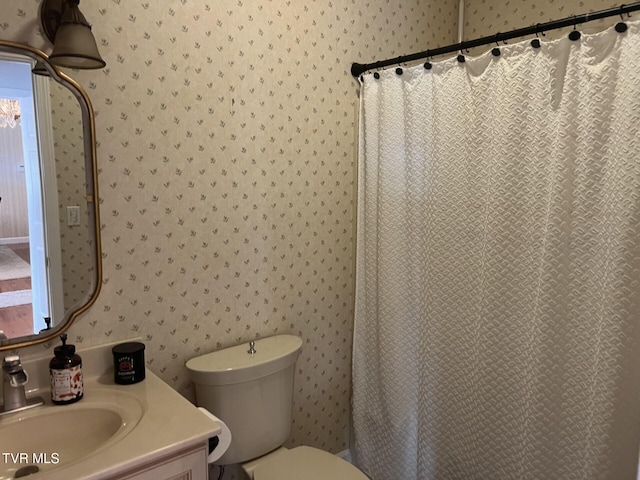 bathroom featuring toilet, a shower with curtain, and vanity