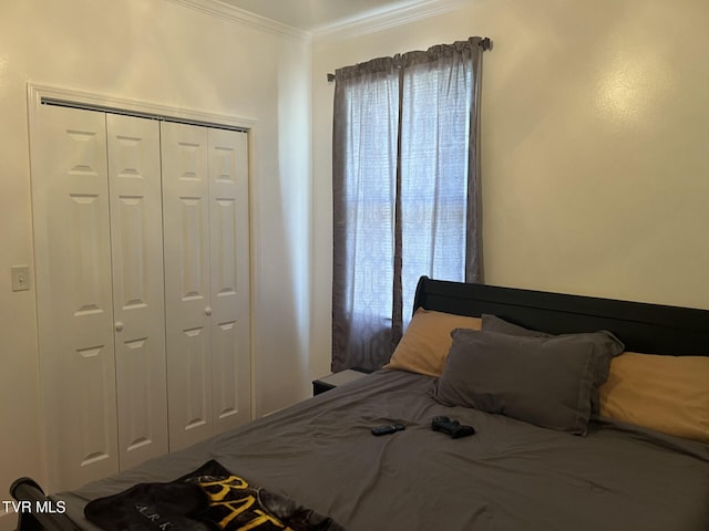 bedroom with crown molding and a closet