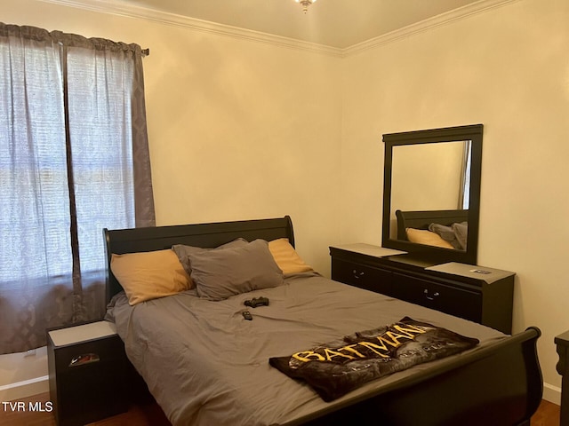 bedroom with wood-type flooring and crown molding