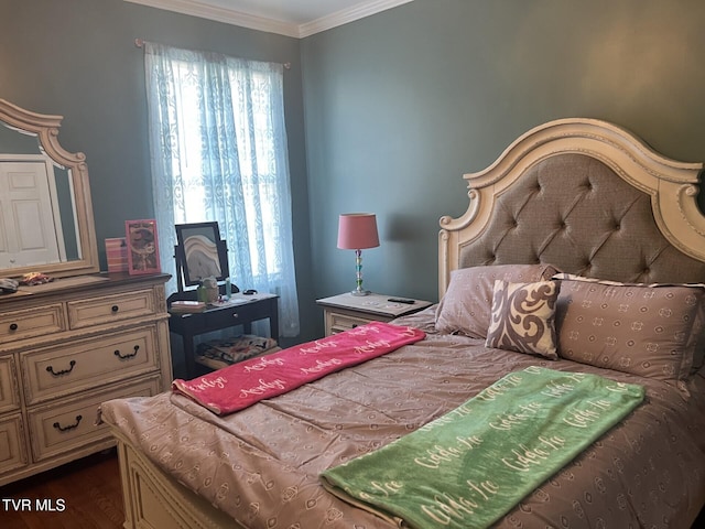 bedroom with dark hardwood / wood-style flooring and crown molding