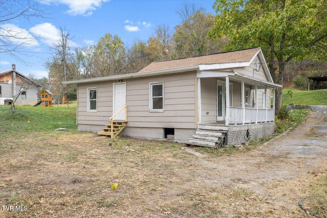 view of front of house with a front yard and a porch