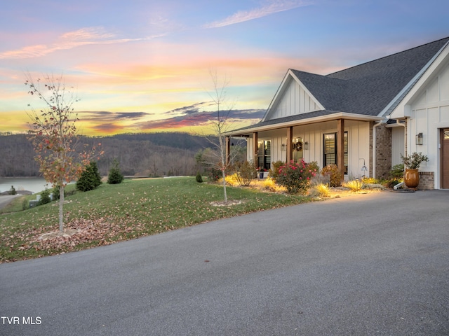 exterior space featuring a porch and a lawn