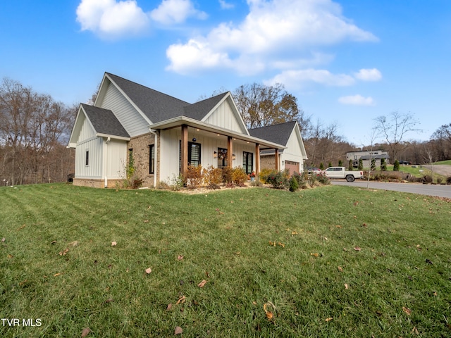 view of home's exterior featuring covered porch and a yard