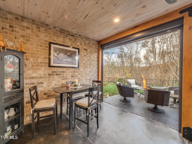 175 Deer Ridge Ct, Butler, TN 37640 - dining area with concrete floors, brick wall, and wood ceiling