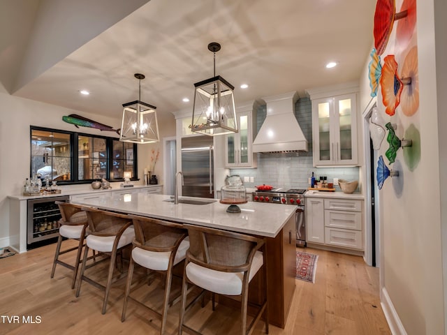 175 Deer Ridge Ct, Butler, TN 37640 - kitchen featuring beverage cooler, premium appliances, custom exhaust hood, white cabinetry, and light wood-type flooring