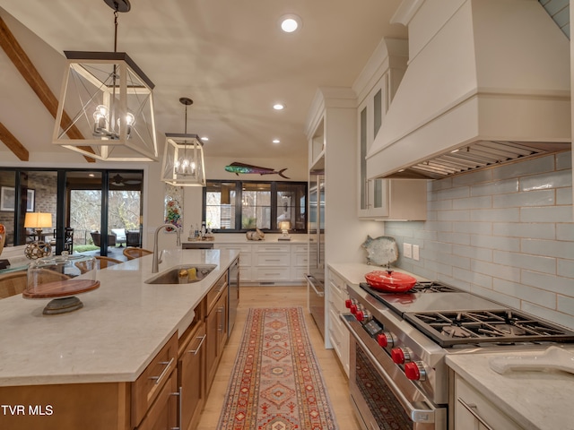 kitchen with a large island, custom range hood, high quality appliances, and light stone countertops