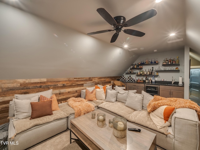 carpeted living room with beverage cooler, wet bar, lofted ceiling, and ceiling fan