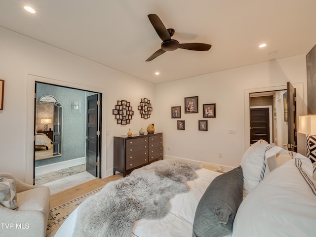 bedroom featuring light wood-type flooring, a spacious closet, ceiling fan, and a closet