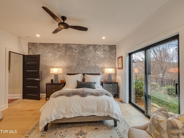 bedroom featuring access to outside, light hardwood / wood-style floors, and ceiling fan