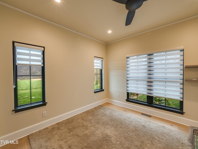 spare room with ornamental molding, hardwood / wood-style flooring, and ceiling fan