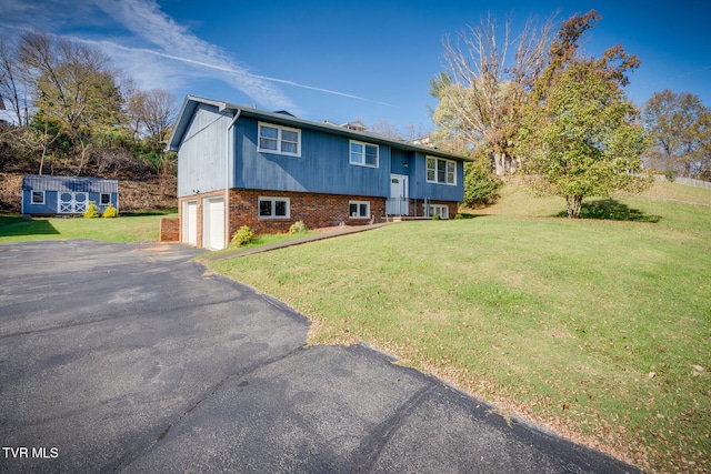 back of house with a yard and a garage