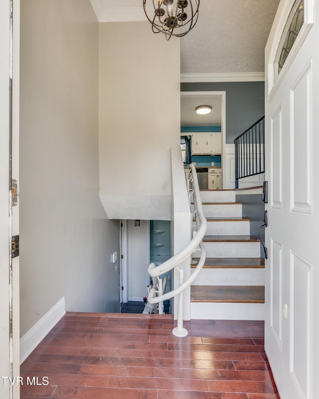 stairway with hardwood / wood-style flooring and crown molding