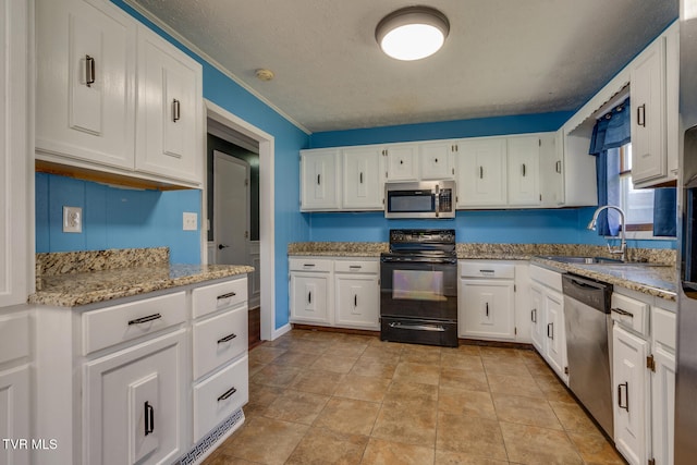 kitchen with light stone countertops, sink, white cabinets, and stainless steel appliances