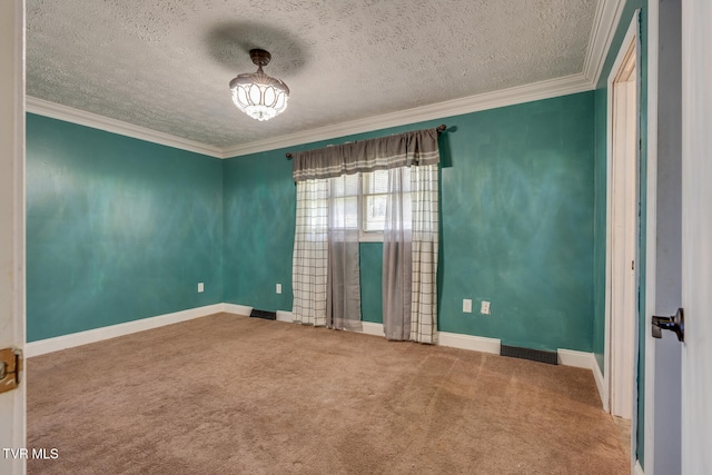 carpeted spare room featuring a textured ceiling and crown molding