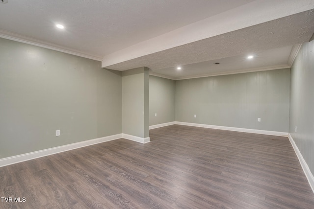 basement featuring a textured ceiling, crown molding, and dark wood-type flooring