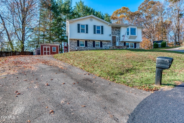 split foyer home featuring a storage unit and a front yard