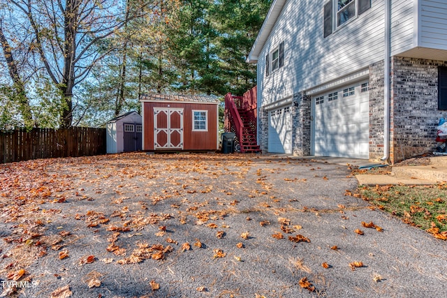 view of property exterior with a shed and a garage