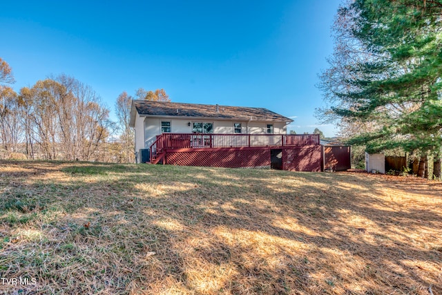 back of house featuring cooling unit, a yard, and a deck