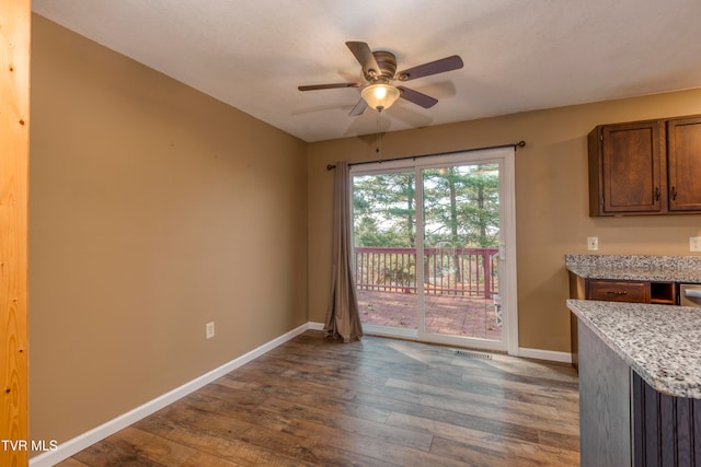 dining space with wood-type flooring and ceiling fan