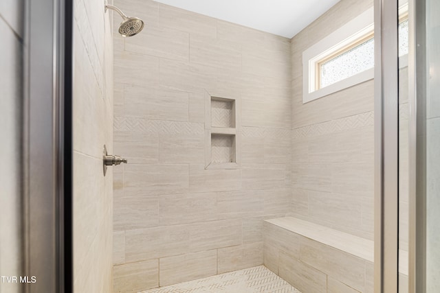 bathroom featuring a tile shower