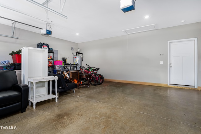 garage featuring a garage door opener and water heater