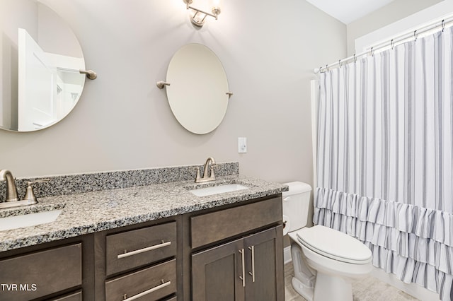 bathroom featuring tile patterned flooring, vanity, and toilet