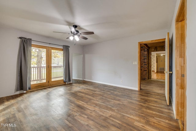 spare room with a ceiling fan, wood finished floors, baseboards, and french doors