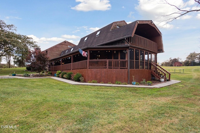 back of house featuring a lawn and a deck