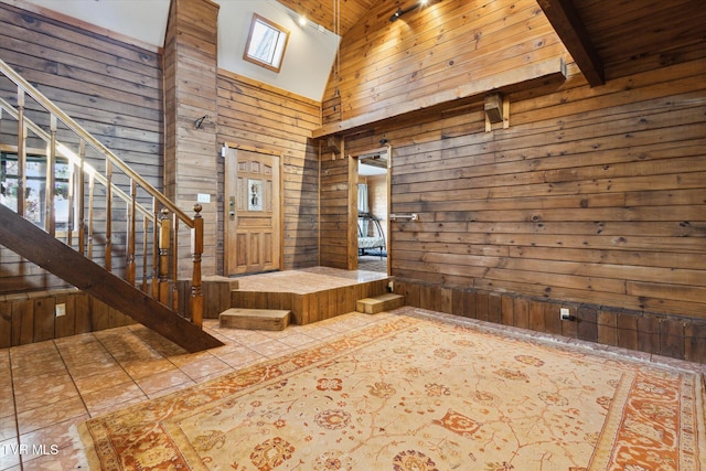 entrance foyer featuring high vaulted ceiling, wooden walls, tile patterned flooring, and beam ceiling