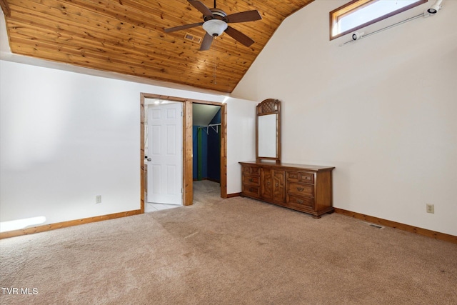 unfurnished bedroom with wood ceiling, vaulted ceiling, ceiling fan, a closet, and a walk in closet