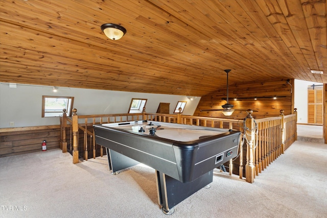 rec room with vaulted ceiling with skylight, wood ceiling, wooden walls, and light carpet