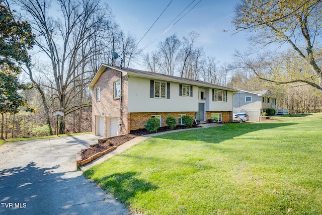 split foyer home with a garage and a front lawn